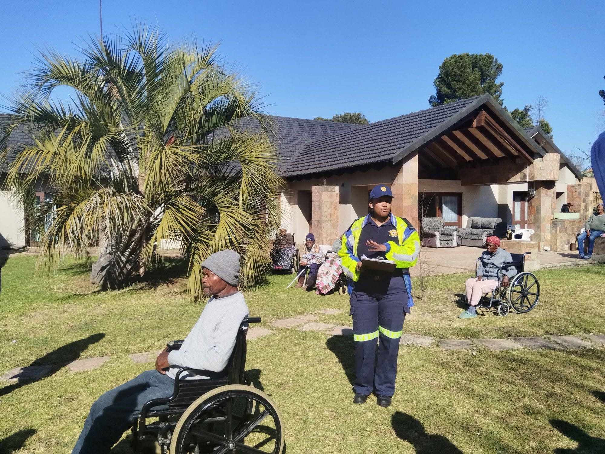 A caregiver checking in with residents in the garden