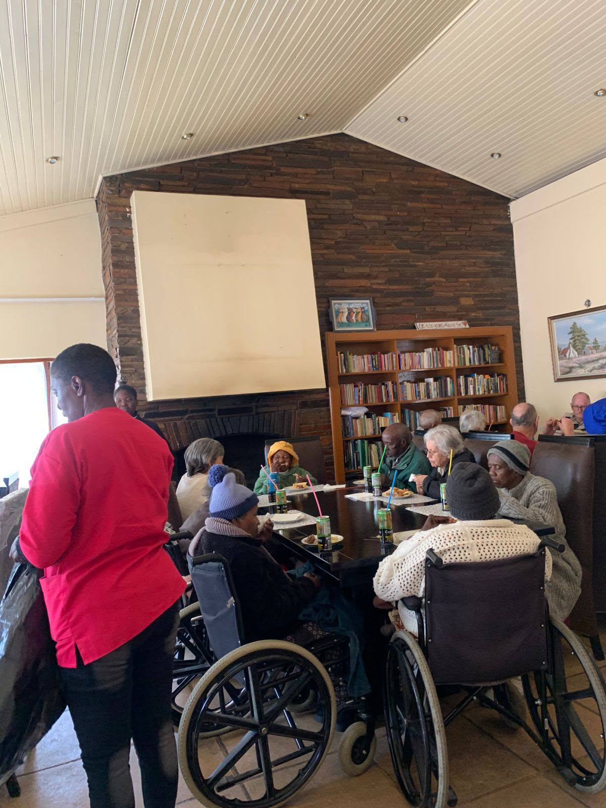 Residents enjoying tea and snacks together in the lounge