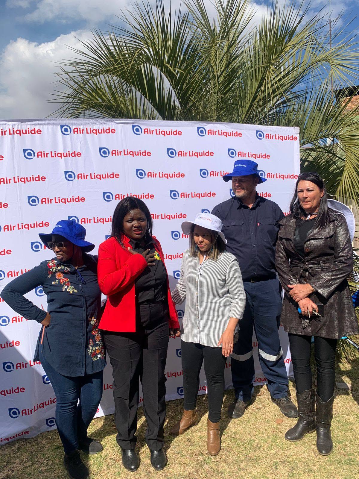 Air Liquide team visiting with blankets and groceries for residents